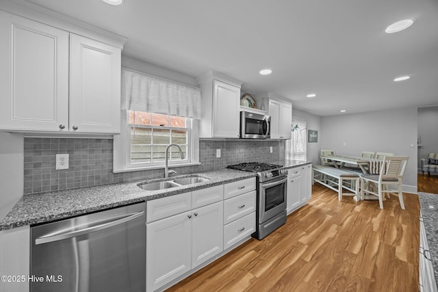 209 E Main St, Washington, NC 27889 - kitchen with stainless steel appliances, light wood-style flooring, white cabinets, light stone counters, and recessed lighting