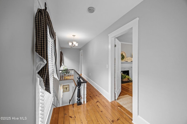 209 E Main St, Washington, NC 27889 - corridor with an upstairs landing, light wood-style floors, and a chandelier