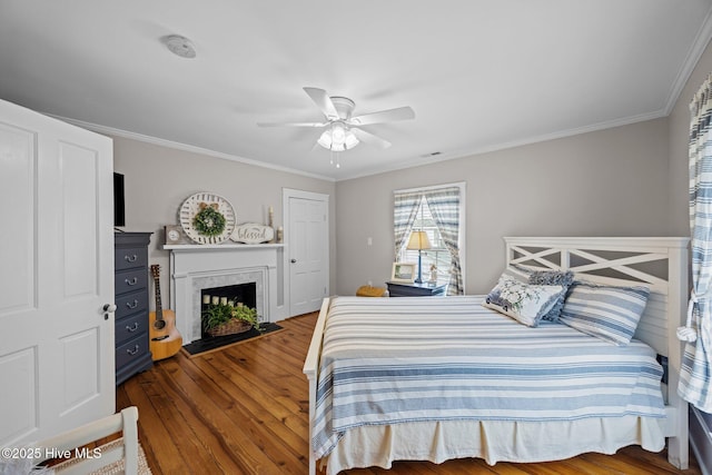209 E Main St, Washington, NC 27889 - bedroom with wood finished floors, a fireplace with flush hearth, ornamental molding, and a ceiling fan
