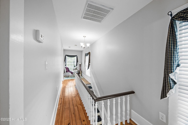 209 E Main St, Washington, NC 27889 - hallway with an upstairs landing, light wood-type flooring, and a chandelier