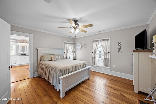 209 E Main St, Washington, NC 27889 - bedroom with crown molding, hardwood / wood-style floors, multiple windows, ensuite bath, and a ceiling fan