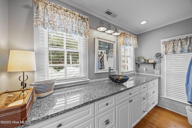 209 E Main St, Washington, NC 27889 - bathroom with crown molding, healthy amount of natural light, recessed lighting, vanity, and wood finished floors
