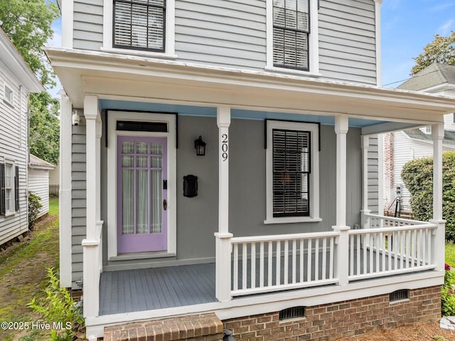 209 E Main St, Washington, NC 27889 - doorway to property featuring covered porch and crawl space