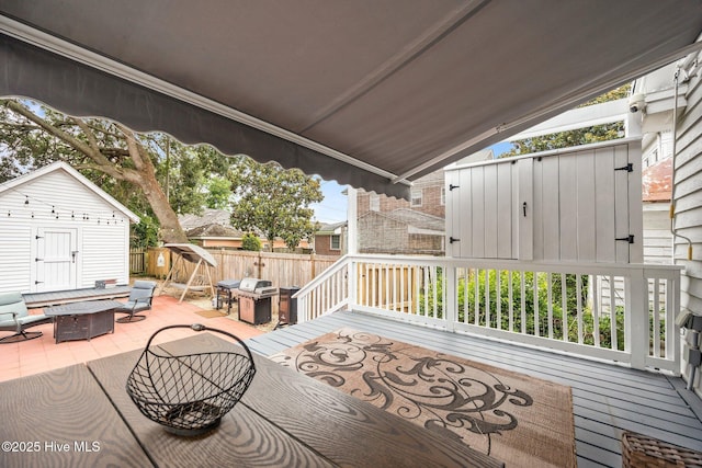 209 E Main St, Washington, NC 27889 - wooden terrace featuring a shed, an outdoor living space with a fire pit, and a patio