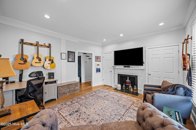 209 E Main St, Washington, NC 27889 - living room featuring light wood finished floors, recessed lighting, crown molding, a fireplace with flush hearth, and a desk