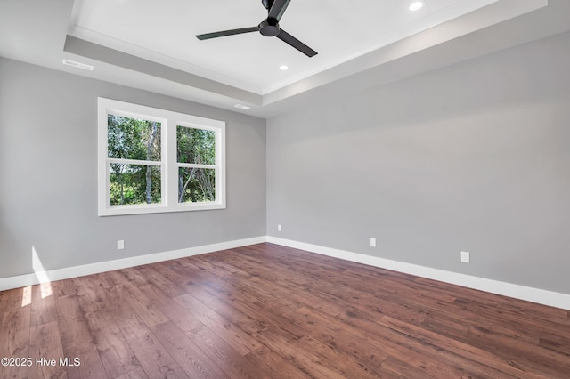 5988 Gray Squirrel Path, Southport, NC 28461 - spare room featuring a ceiling fan, a tray ceiling, wood finished floors, and recessed lighting