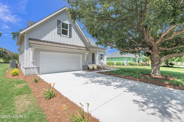 5988 Gray Squirrel Path, Southport, NC 28461 - modern farmhouse style home with board and batten siding, concrete driveway, a front lawn, and a garage