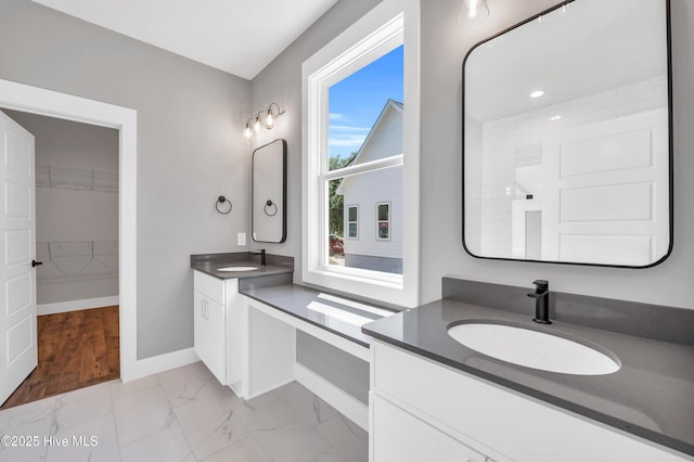 5988 Gray Squirrel Path, Southport, NC 28461 - full bathroom featuring marble finish floors, two vanities, and a walk in closet