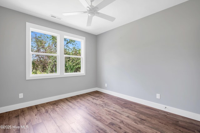 5988 Gray Squirrel Path, Southport, NC 28461 - empty room featuring wood finished floors and ceiling fan