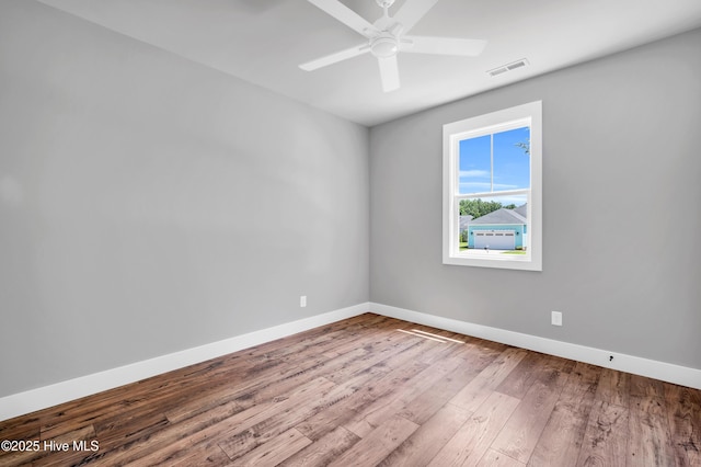 5988 Gray Squirrel Path, Southport, NC 28461 - unfurnished room featuring wood finished floors and ceiling fan