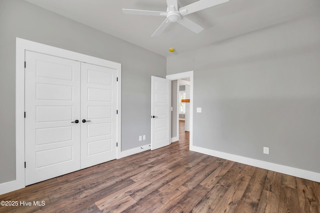 5988 Gray Squirrel Path, Southport, NC 28461 - unfurnished bedroom featuring wood finished floors, a closet, and a ceiling fan