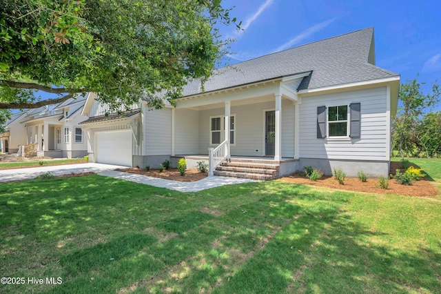 5988 Gray Squirrel Path, Southport, NC 28461 - view of front of house featuring a porch, driveway, a front lawn, and a garage