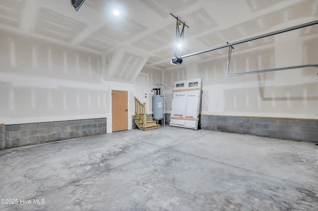 5988 Gray Squirrel Path, Southport, NC 28461 - garage with water heater, concrete block wall, and a garage door opener