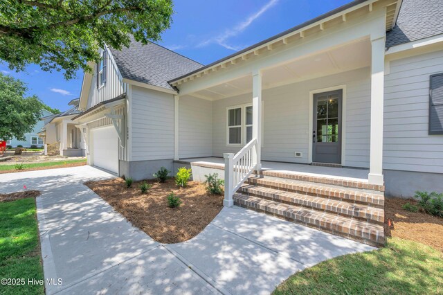 5988 Gray Squirrel Path, Southport, NC 28461 - view of front facade with a porch, roof with shingles, driveway, and an attached garage