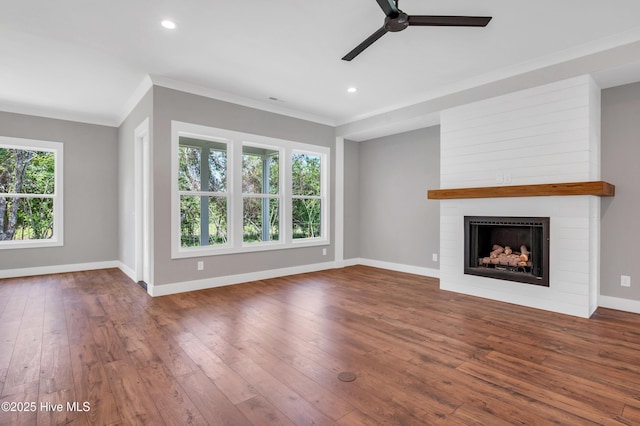 5988 Gray Squirrel Path, Southport, NC 28461 - unfurnished living room featuring ceiling fan, a fireplace, hardwood / wood-style flooring, ornamental molding, and recessed lighting