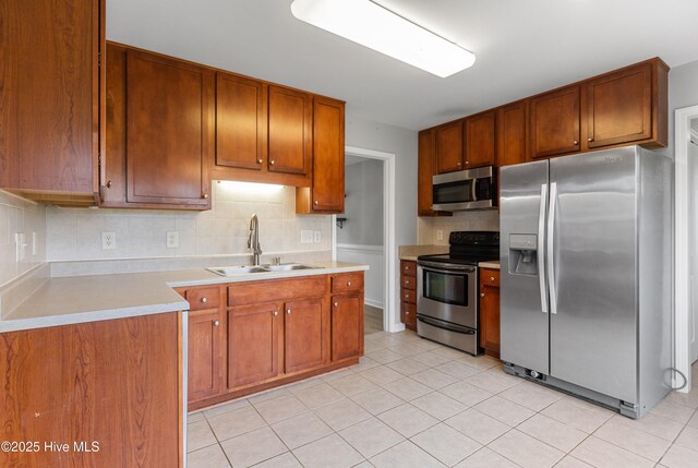 225 Woodshire Dr, Lillington, NC 27546 - kitchen with appliances with stainless steel finishes, decorative backsplash, light countertops, and light tile patterned flooring