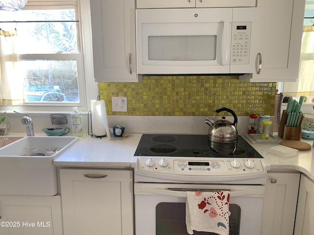 606 Ivey Cir, Wilmington, NC 28401 - kitchen featuring white appliances, healthy amount of natural light, and white cabinets