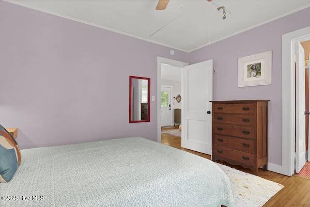 606 Ivey Cir, Wilmington, NC 28401 - bedroom featuring attic access, wood finished floors, crown molding, and ceiling fan