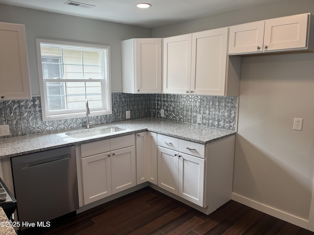 832 Fanning St, Wilmington, NC 28401 - kitchen featuring dishwasher, dark wood finished floors, white cabinets, light stone counters, and decorative backsplash