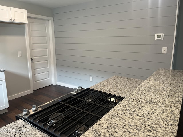 832 Fanning St, Wilmington, NC 28401 - kitchen featuring dark wood-style floors, white cabinets, light stone counters, and stovetop