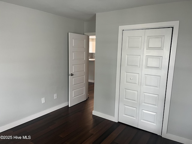 832 Fanning St, Wilmington, NC 28401 - unfurnished bedroom with dark wood-style flooring and a closet