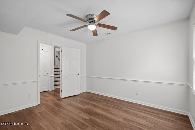 2544 Blake Trl, Wilmington, NC 28409 - spare room featuring a ceiling fan, wood finished floors, and stairs