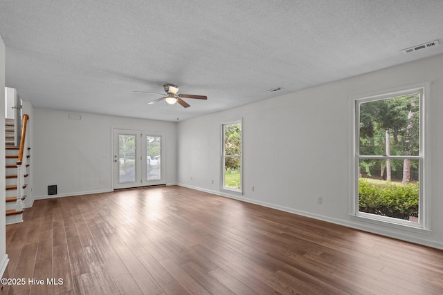 2544 Blake Trl, Wilmington, NC 28409 - unfurnished living room with a ceiling fan, a textured ceiling, stairs, and wood finished floors