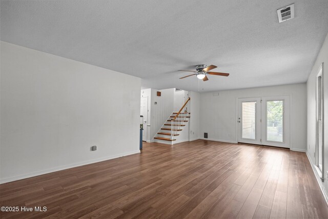 2544 Blake Trl, Wilmington, NC 28409 - unfurnished living room featuring stairs, ceiling fan, dark wood-type flooring, and a textured ceiling