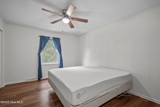 2544 Blake Trl, Wilmington, NC 28409 - bedroom with wood finished floors, a ceiling fan, and a textured ceiling