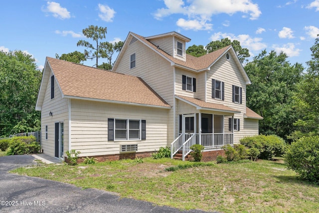 2544 Blake Trl, Wilmington, NC 28409 - traditional home with roof with shingles, a front lawn, and a sunroom