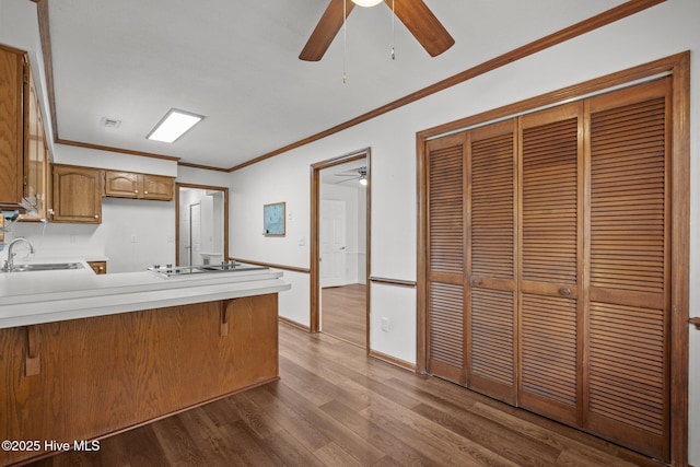 2544 Blake Trl, Wilmington, NC 28409 - kitchen with a ceiling fan, a peninsula, ornamental molding, wood finished floors, and electric cooktop