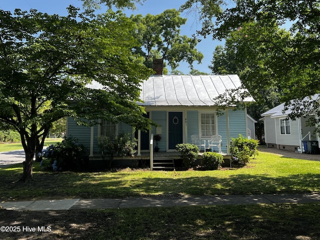 401 E Queen St, Edenton, NC 27932 - bungalow-style house with covered porch, a chimney, a front lawn, a metal roof, and a standing seam roof