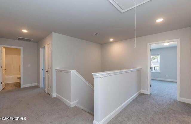 5705 Sloop Ct, New Bern, NC 28560 - corridor with attic access, an upstairs landing, carpet, and recessed lighting