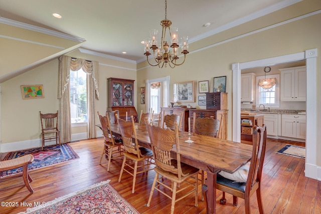 214 Nun St, Wilmington, NC 28401 - dining room with light wood-type flooring, a chandelier, crown molding, and recessed lighting