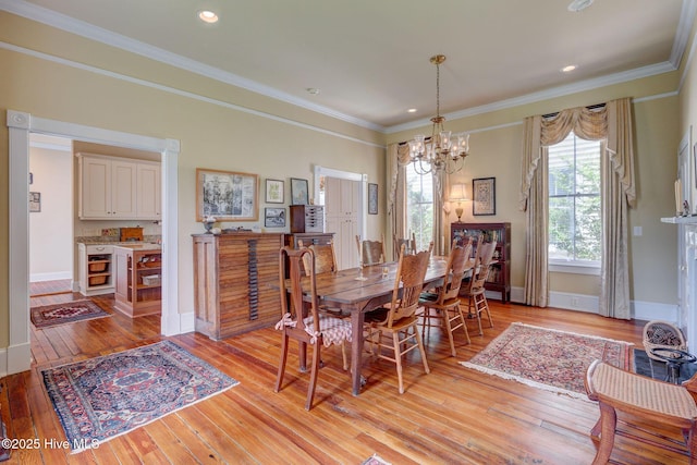 214 Nun St, Wilmington, NC 28401 - dining area with a chandelier, light wood-style flooring, crown molding, and recessed lighting