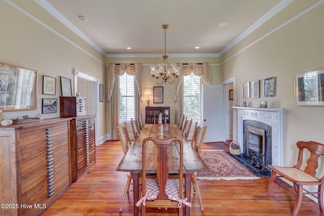 214 Nun St, Wilmington, NC 28401 - dining room with a chandelier, ornamental molding, light wood-type flooring, a premium fireplace, and recessed lighting