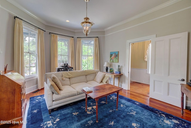 214 Nun St, Wilmington, NC 28401 - living room with wood finished floors, crown molding, a chandelier, and a wainscoted wall
