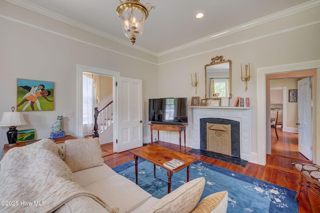 214 Nun St, Wilmington, NC 28401 - living area with a fireplace with flush hearth, wood finished floors, ornamental molding, stairway, and recessed lighting