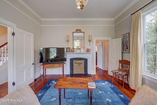 214 Nun St, Wilmington, NC 28401 - living room with ornamental molding, healthy amount of natural light, wood finished floors, and a fireplace with flush hearth