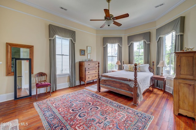 214 Nun St, Wilmington, NC 28401 - bedroom with multiple windows, crown molding, light wood finished floors, and ceiling fan