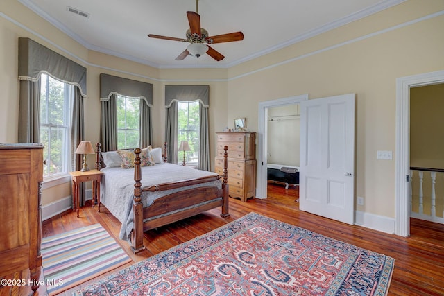 214 Nun St, Wilmington, NC 28401 - bedroom with wood finished floors, ornamental molding, a spacious closet, and a ceiling fan