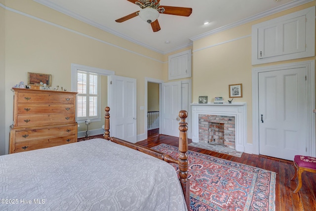 214 Nun St, Wilmington, NC 28401 - bedroom with ornamental molding, wood finished floors, a fireplace, and a ceiling fan