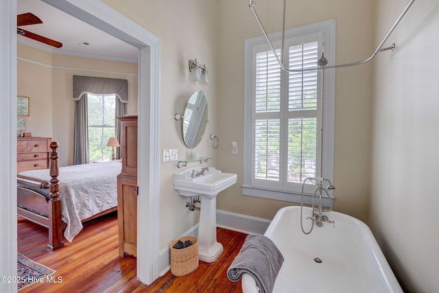 214 Nun St, Wilmington, NC 28401 - bathroom with a soaking tub, wood finished floors, ornamental molding, and ceiling fan