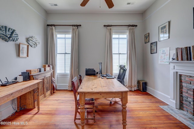 214 Nun St, Wilmington, NC 28401 - office area featuring a ceiling fan, a brick fireplace, and light wood finished floors