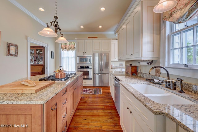 214 Nun St, Wilmington, NC 28401 - kitchen with stainless steel appliances, crown molding, light wood finished floors, recessed lighting, and hanging light fixtures