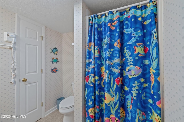 10300 Coast Guard Rd Unit E206Point, Emerald Villas, Emerald Isle, NC 28594 - full bath with a textured ceiling, tile patterned flooring, wallpapered walls, and a shower with shower curtain