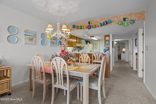 10300 Coast Guard Rd Unit E206Point, Emerald Villas, Emerald Isle, NC 28594 - dining space with light colored carpet and a chandelier