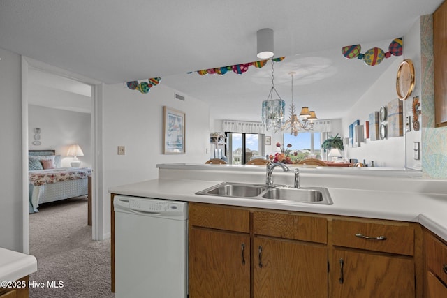 10300 Coast Guard Rd Unit E206Point, Emerald Villas, Emerald Isle, NC 28594 - kitchen featuring dishwasher, carpet, light countertops, a chandelier, and brown cabinetry