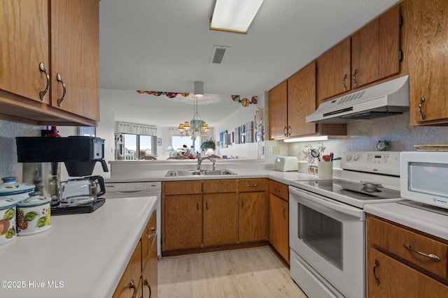 10300 Coast Guard Rd Unit E206Point, Emerald Villas, Emerald Isle, NC 28594 - kitchen with under cabinet range hood, white appliances, and light countertops