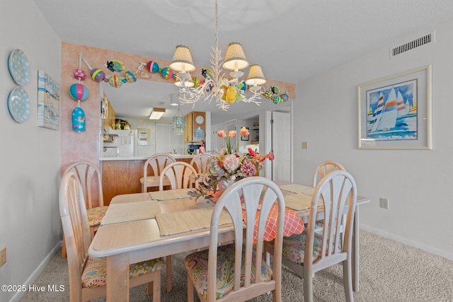 10300 Coast Guard Rd Unit E206Point, Emerald Villas, Emerald Isle, NC 28594 - carpeted dining area featuring a chandelier and baseboards